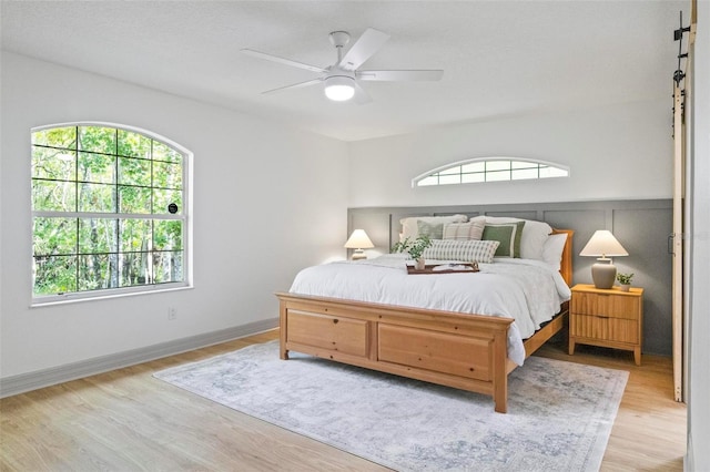 bedroom with light hardwood / wood-style floors and ceiling fan