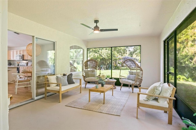 sunroom / solarium featuring ceiling fan