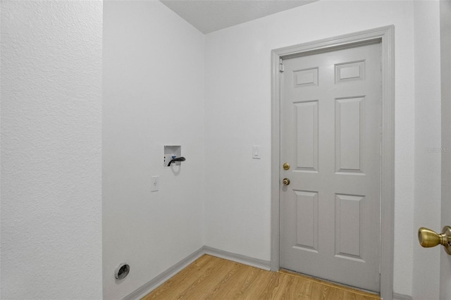 laundry room featuring hookup for a washing machine and light wood-type flooring