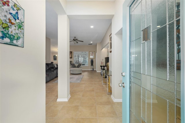 hall featuring light tile patterned floors