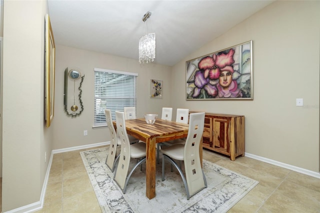 dining space with light tile patterned floors and an inviting chandelier