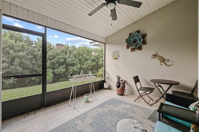 sunroom with a wealth of natural light, wooden ceiling, and ceiling fan