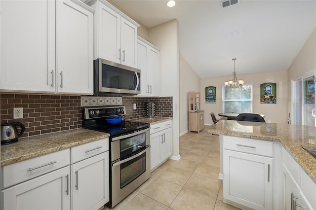 kitchen with an inviting chandelier, hanging light fixtures, vaulted ceiling, white cabinetry, and stainless steel appliances