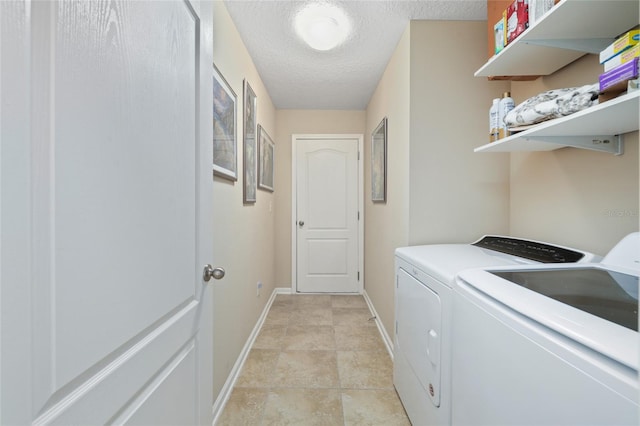 laundry area featuring independent washer and dryer, a textured ceiling, and light tile patterned floors