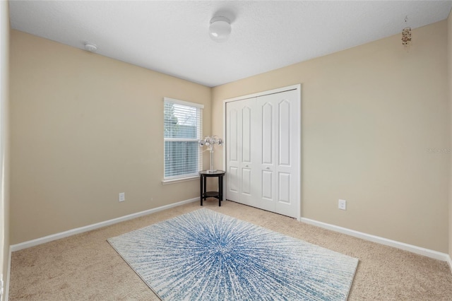 carpeted bedroom with a closet