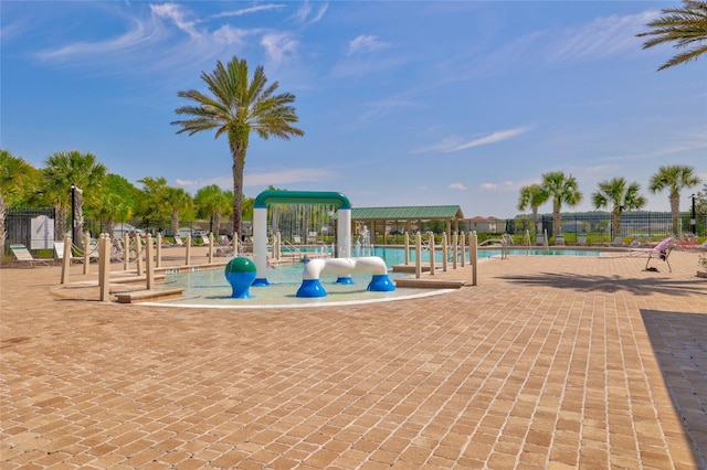 view of jungle gym with a community pool