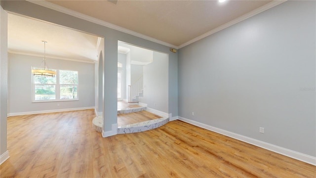 unfurnished living room with crown molding and hardwood / wood-style floors