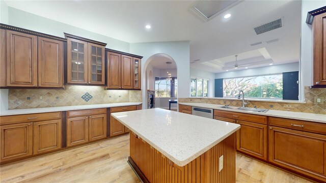 23 Augusta Trl, Palm Coast, FL 32137 - kitchen with visible vents, stainless steel dishwasher, a tray ceiling, a sink, and light wood finished floors