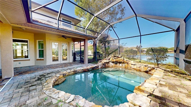 view of pool with a patio, ceiling fan, a lanai, and a hot tub