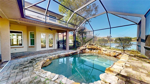 23 Augusta Trl, Palm Coast, FL 32137 - outdoor pool featuring a patio, a ceiling fan, glass enclosure, and french doors