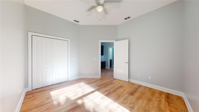 unfurnished bedroom featuring a closet, ceiling fan, and light hardwood / wood-style flooring