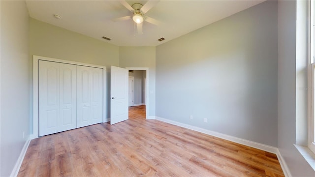 unfurnished bedroom featuring light hardwood / wood-style flooring, a closet, and ceiling fan