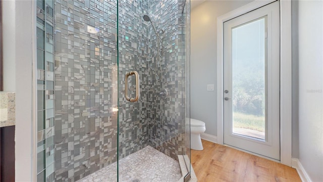 bathroom with toilet, an enclosed shower, hardwood / wood-style flooring, and vanity