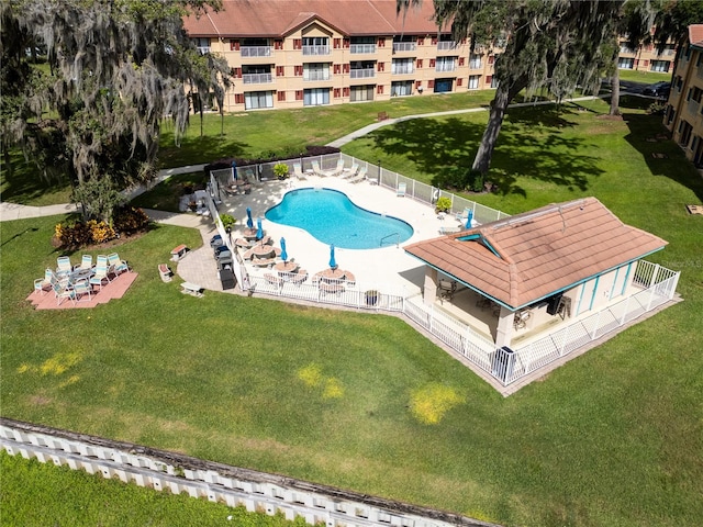 view of pool with a yard and a patio