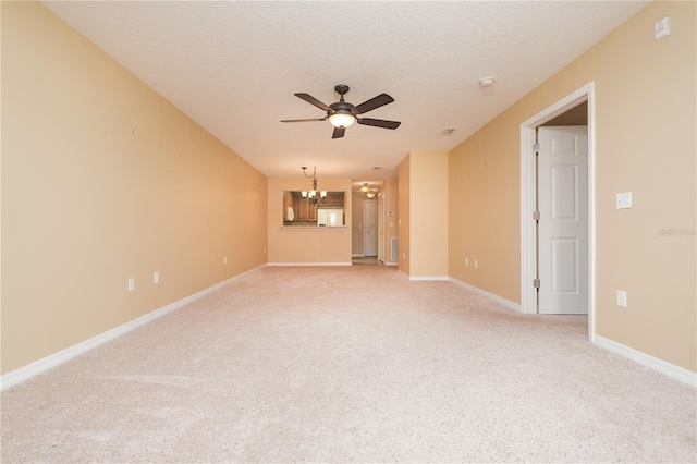 interior space featuring light carpet, a textured ceiling, and ceiling fan with notable chandelier