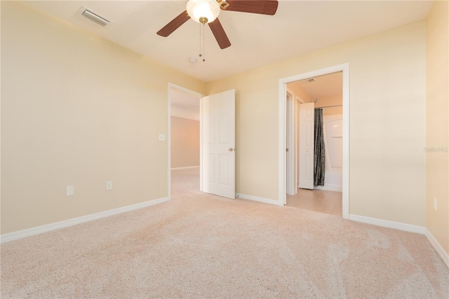 unfurnished bedroom with ceiling fan and light colored carpet