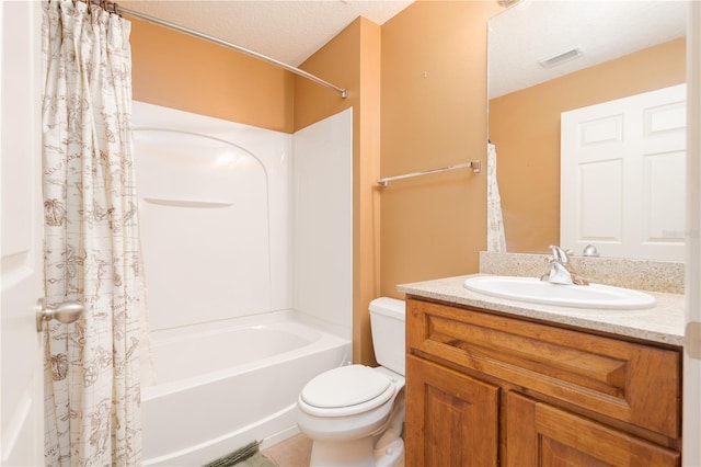 full bathroom featuring vanity, toilet, a textured ceiling, and shower / tub combo