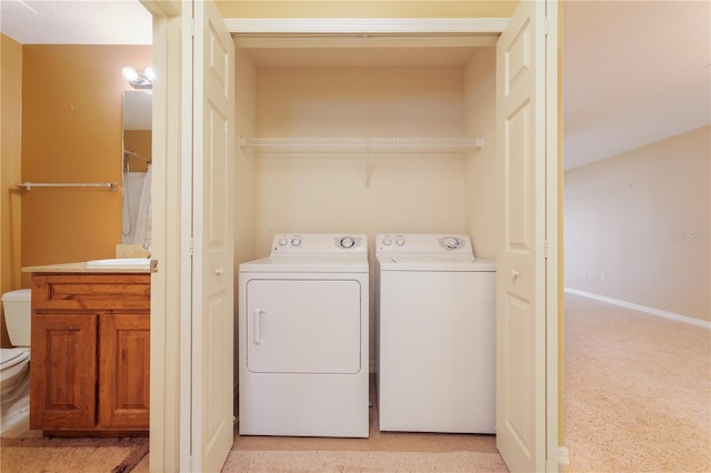 laundry room with light colored carpet and separate washer and dryer