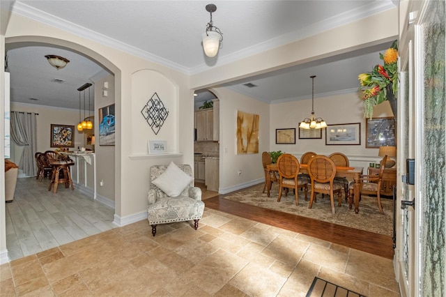 dining area with light hardwood / wood-style floors and crown molding