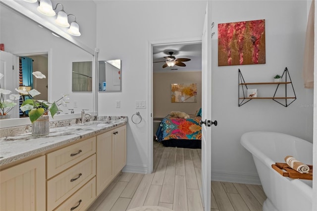 bathroom featuring vanity, a bathtub, wood-type flooring, and ceiling fan