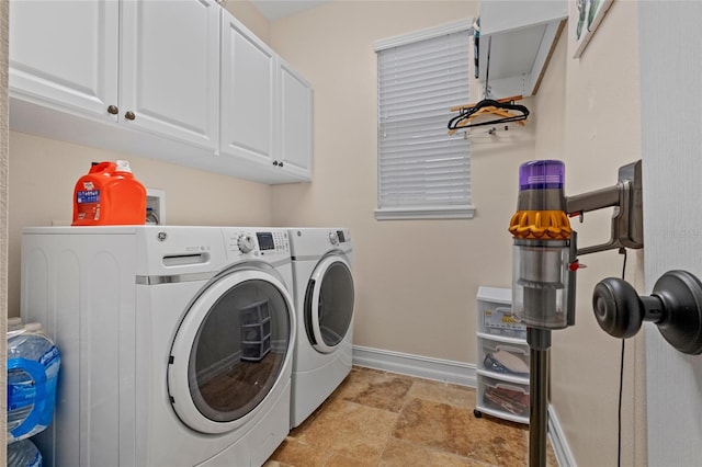 laundry area featuring cabinets and washing machine and clothes dryer