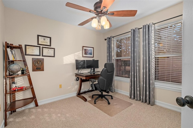 carpeted home office with ceiling fan