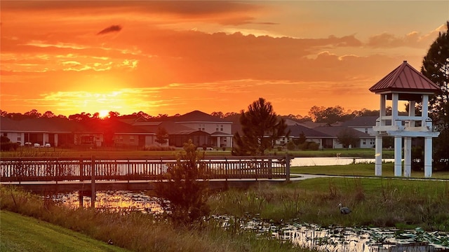 view of property's community with a water view and a yard