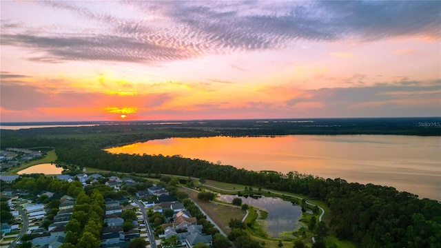 aerial view at dusk with a water view