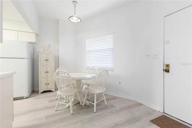 dining space featuring light wood-type flooring