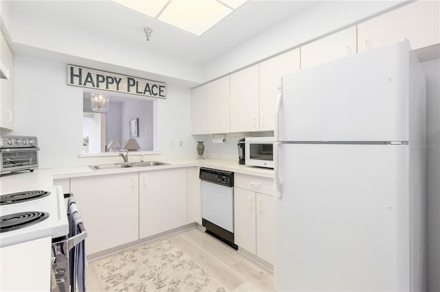 kitchen with white cabinets, light hardwood / wood-style flooring, sink, and white appliances