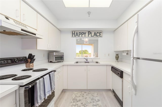 kitchen with light hardwood / wood-style flooring, white appliances, sink, and white cabinets