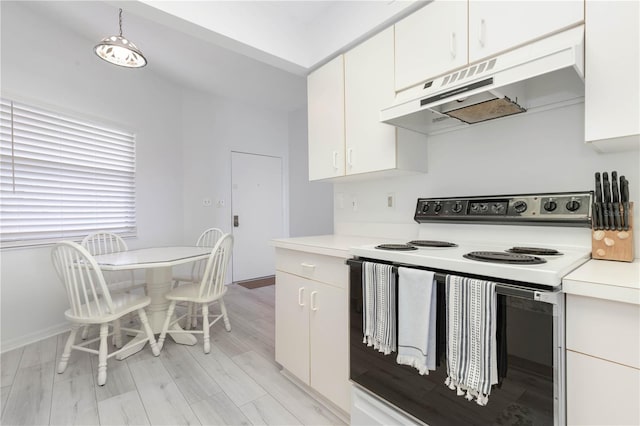 kitchen featuring white electric stove, white cabinetry, pendant lighting, and light hardwood / wood-style floors