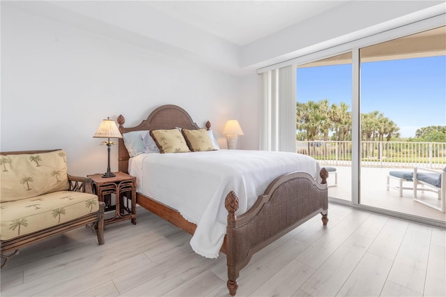 bedroom featuring access to outside and light hardwood / wood-style flooring