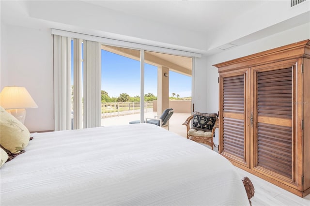 bedroom with light wood-type flooring and access to outside