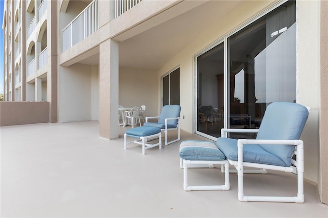 view of patio featuring a balcony