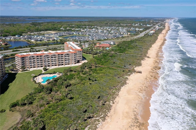 bird's eye view featuring a water view and a beach view