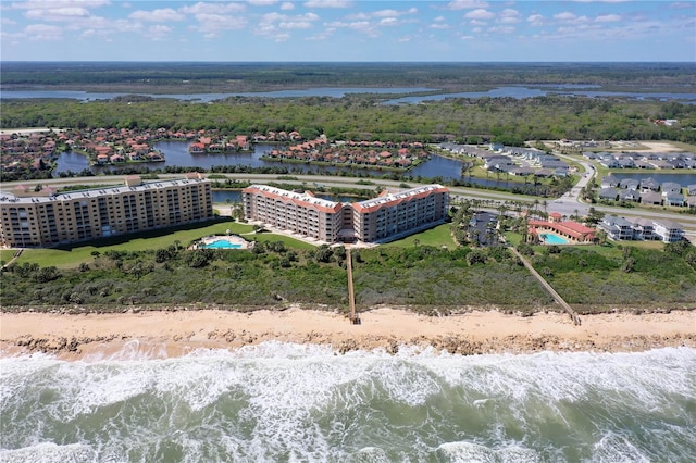 drone / aerial view with a beach view and a water view