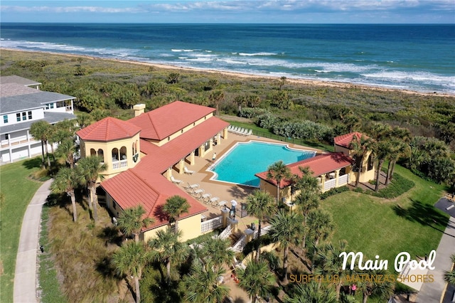 aerial view with a water view and a beach view