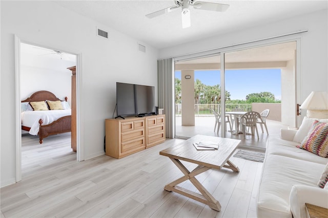 living room with light wood-type flooring and ceiling fan