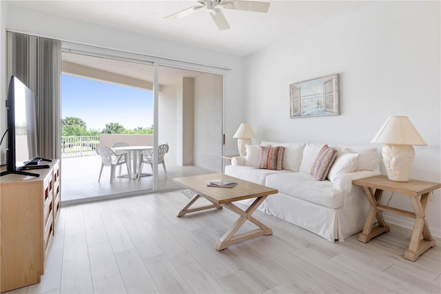 living room featuring light hardwood / wood-style flooring and ceiling fan