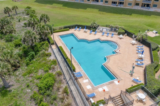 view of swimming pool featuring a yard and a patio