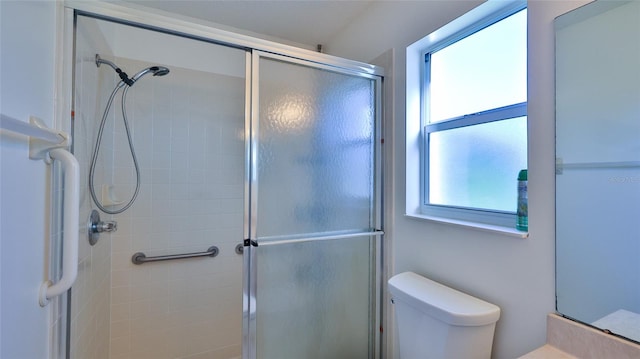 full bathroom with a shower stall and toilet