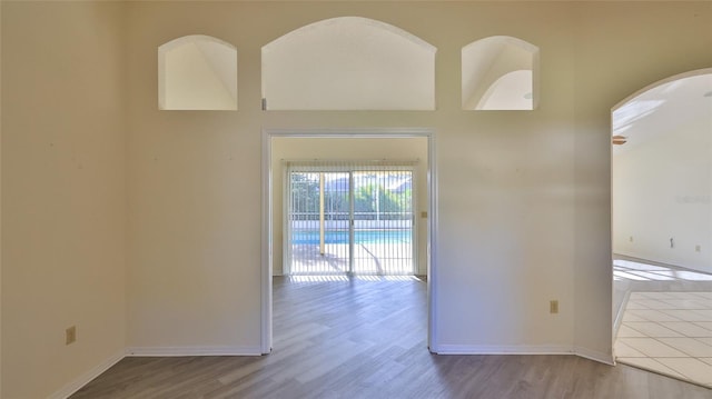 empty room with wood finished floors and baseboards