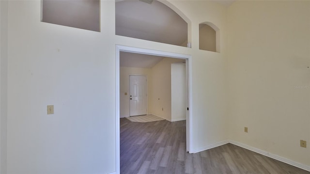 interior space featuring baseboards and wood finished floors