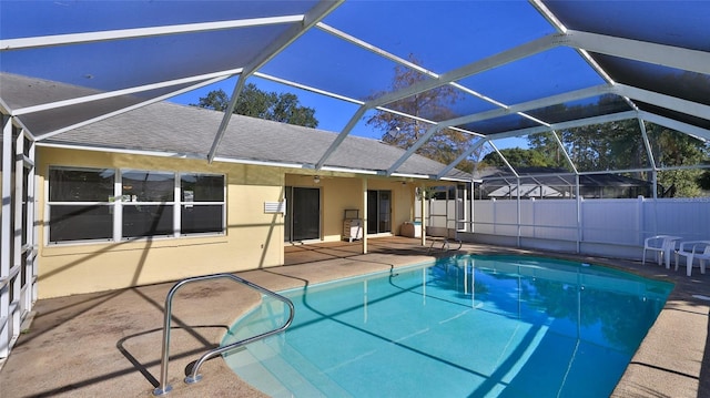 view of swimming pool with a patio area, a lanai, a fenced in pool, and fence