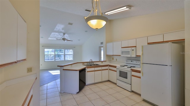 kitchen with light tile patterned flooring, a peninsula, white appliances, a sink, and light countertops