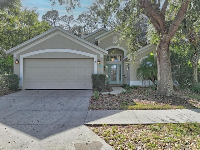 32 Shinnecock Dr, Palm Coast, FL 32137 - view of front of home featuring stucco siding, concrete driveway, and a garage