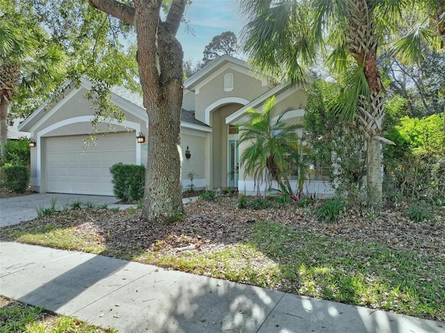 32 Shinnecock Dr, Palm Coast, FL 32137 - view of front of property featuring stucco siding, a garage, and driveway