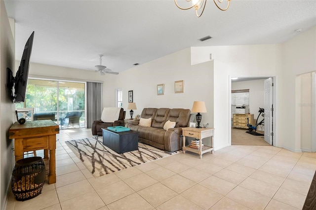 tiled living room with ceiling fan with notable chandelier