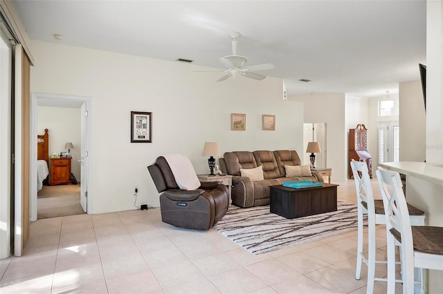 living room featuring light tile patterned floors and ceiling fan